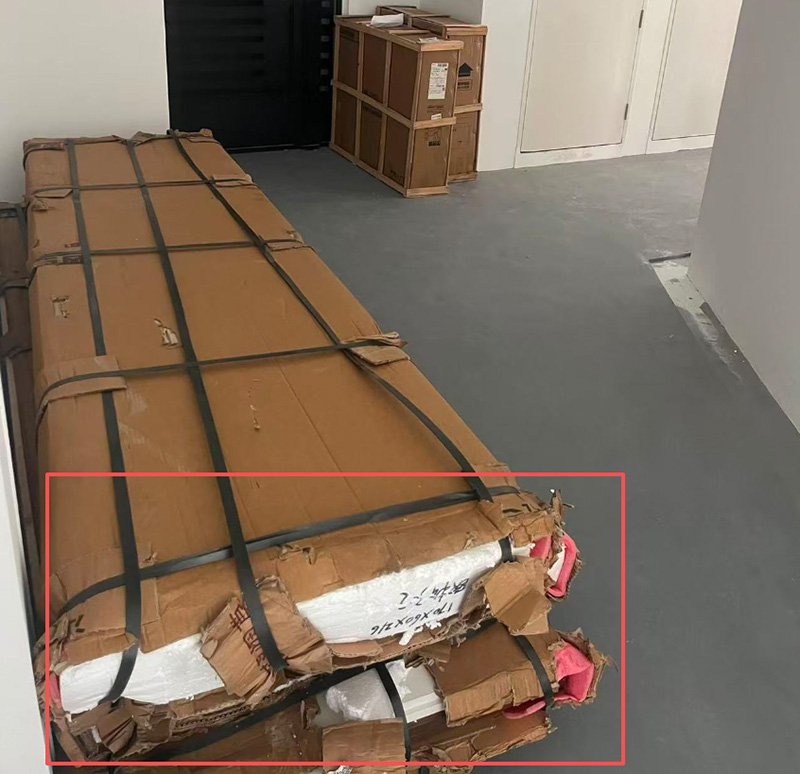 At the time of delivery to the consignee doorstep oversea, partial damage to the outer packaging is clearly visible. The thin cardboard used in this type of packaging lacks sufficient strength to withstand long-distance international transportation, stacking pressure, and multiple handling stages. As a result, even when internal cushioning materials such as foam are present, the weak outer carton is unable to provide adequate protection, leaving the internal packaging and furniture at risk of damage during transit